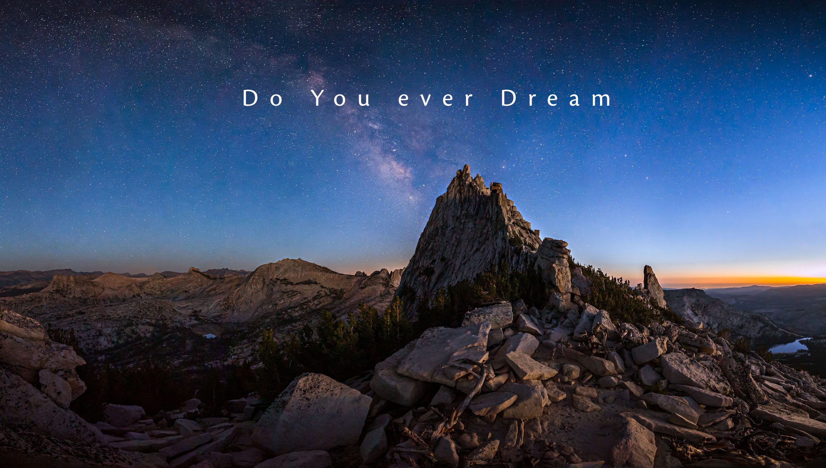 Cathedral Peak in Tuolumne in alpenglow under the Milky Way & stars in Yosemite National Park.